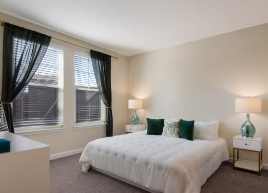 a bedroom with a white bed and green pillows  at The Oasis at Manatee River, Florida