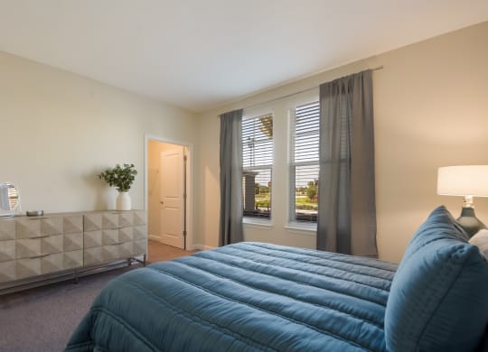 a bedroom with a large bed and two windows  at The Oasis at Manatee River, Florida, 34211