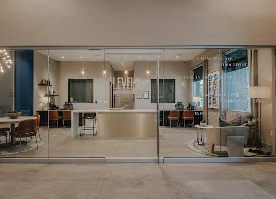 Leasing office with full glass panel, waiting area seating and leasing desks at Level 25 at The Curve by Picerne, Nevada , 89148