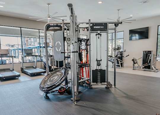 Gym with a SYRRO 250 weight machine at Level 25 at The Curve by Picerne, Las Vegas, NV