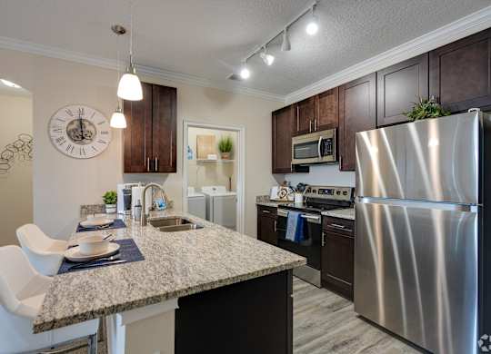 Kitchen with Granite Countertop at The Oasis at Town Center Apartments, Jacksonville, Florida