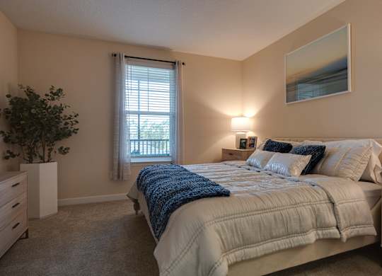 Bedroom with a Large Bed at The Oasis at Town Center Apartments, Florida