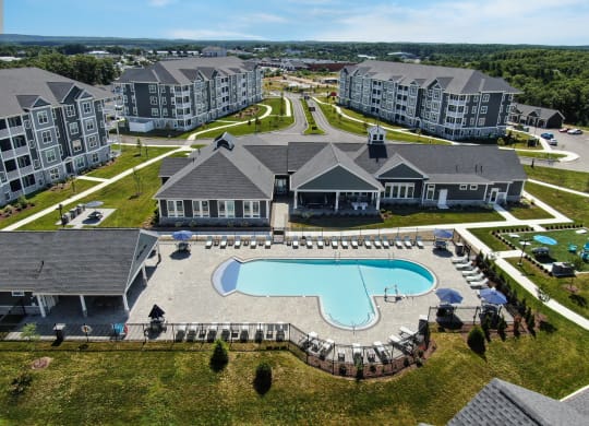 an aerial view of an apartment complex with a swimming pool at The Oasis at Plymouth, Massachusetts