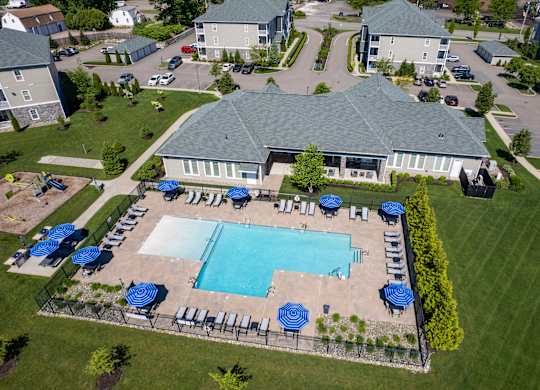 A large building with a pool in front of it.