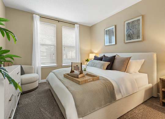 A bedroom with a large bed and a chair  at The Oasis at Lake Bennet, Ocoee, FL, 34761