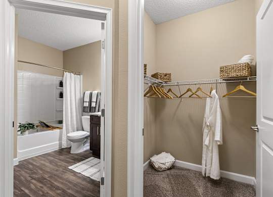 A white toilet is in a bathroom with a white shower curtain.