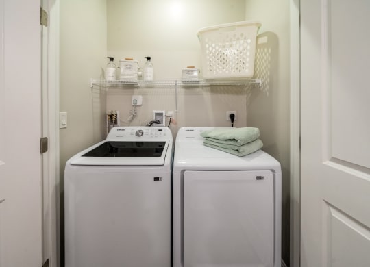 a white washer and dryer in a small laundry room at The Oasis at Plymouth, Plymouth, 02360