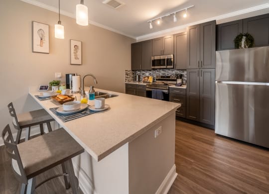 kitchen with island and stainless steel appliances at the preserve at great neck apartments at The Oasis at Plymouth, Plymouth, MA