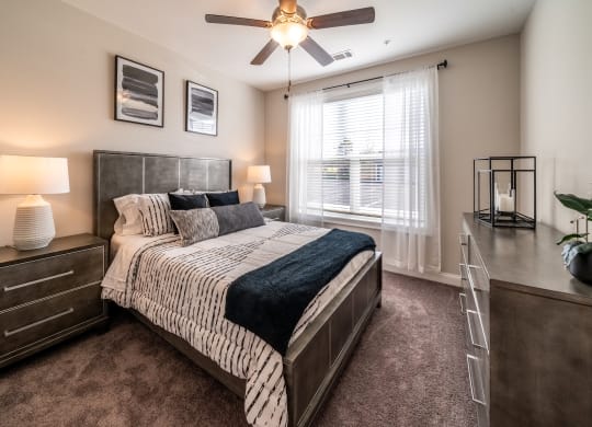 an empty bedroom with a bed and a ceiling fan at The Oasis at Plymouth, Massachusetts