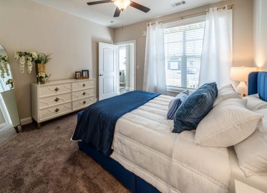 a bedroom with a bed and a dresser and a ceiling fan at The Oasis at Plymouth, Massachusetts