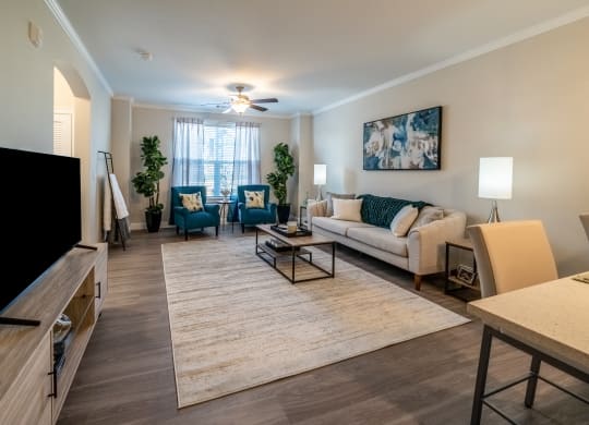 an open living room and dining room with a couch and chairs at The Oasis at Plymouth, Plymouth, MA, 02360