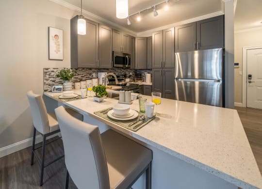 an open kitchen with stainless steel appliances and a large counter top at The Oasis at Plymouth, Massachusetts, 02360