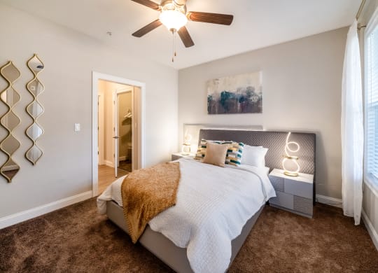 a bedroom with a bed and a ceiling fan at The Oasis at Plymouth, Massachusetts