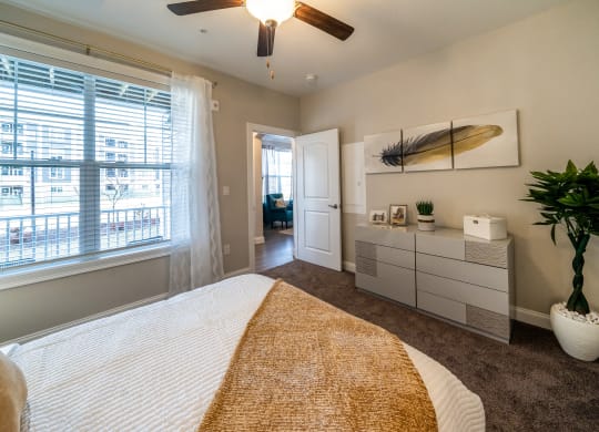 the preserve at ballantyne commons bedroom with a bed and a ceiling fan at The Oasis at Plymouth, Plymouth