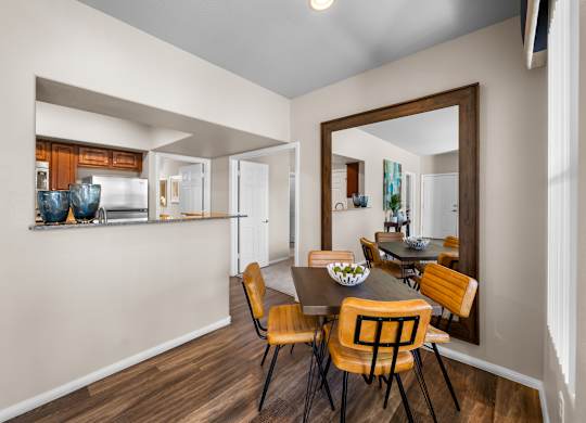 A dining room with a table and chairs.