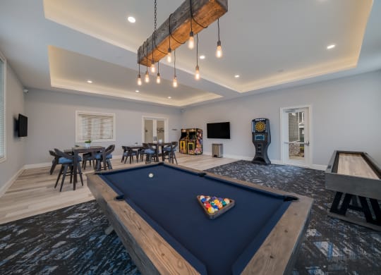 a game room with a blue pool table and a game system at The Oasis at Plymouth, Plymouth, 02360