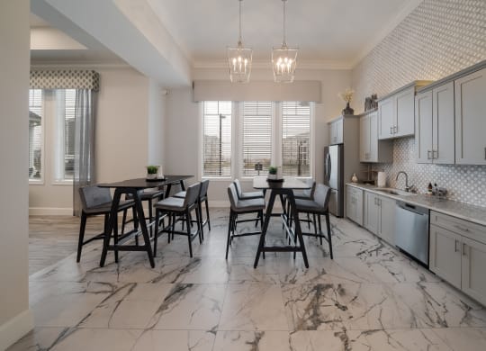 a kitchen and dining room with marble flooring and a table and chairs at The Oasis at Plymouth, Massachusetts