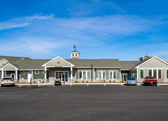 a large building with cars in a parking lot at The Oasis at Plymouth, Plymouth, MA