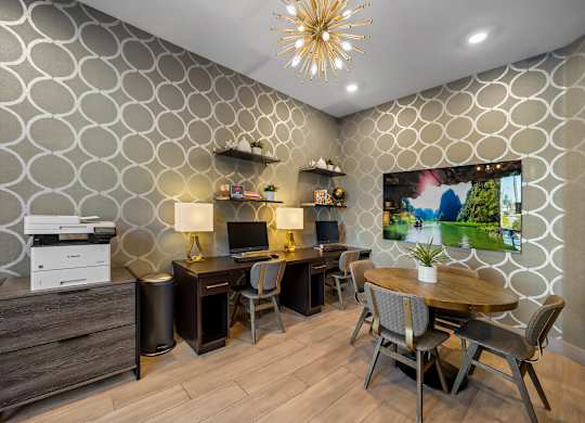 A modern home office with a patterned wallpaper and a wooden desk.
