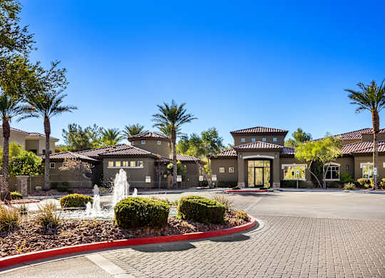 A building with a fountain in front of it.
