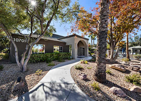 A house numbered 10701 is surrounded by trees and rocks.