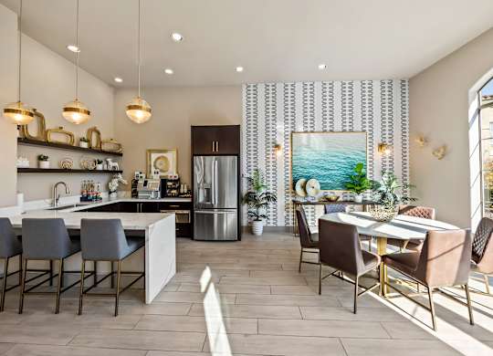 A modern kitchen with a dining table and chairs.