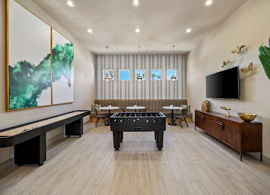 A room with a pool table and a painting on the wall.