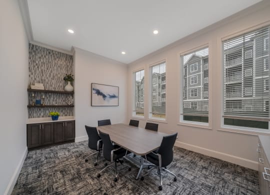 a conference room with a wooden table and chairs and windows at The Oasis at Plymouth, Massachusetts