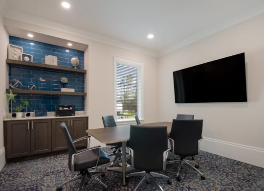 a meeting room with a table and chairs and a flat screen tv  at The Oasis at Manatee River, Florida
