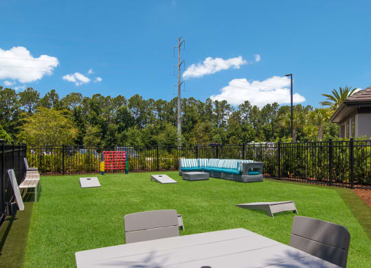 a backyard with a picnic table and chairs and a pool at The Oasis at Town Center, Jacksonville