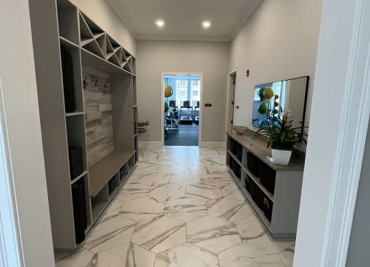 a look down the hallway of a house with a marble tiled floor at The Oasis at Plymouth, Plymouth, MA
