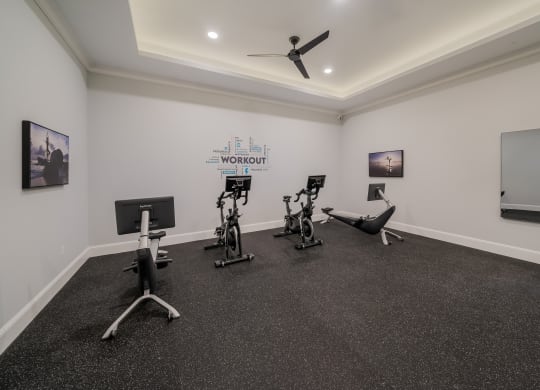 a gym with treadmills and other exercise equipment in a room with white walls at The Oasis at Plymouth, Plymouth, MA, 02360