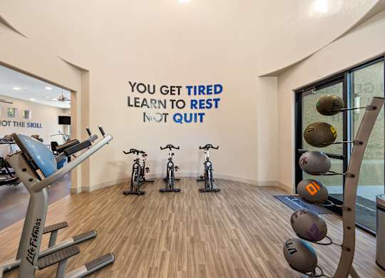 A gym with a motivational quote on the wall.