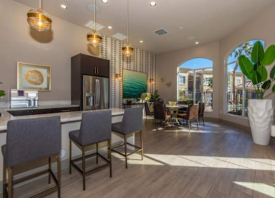 A modern kitchen with a dining area and a view of the backyard.