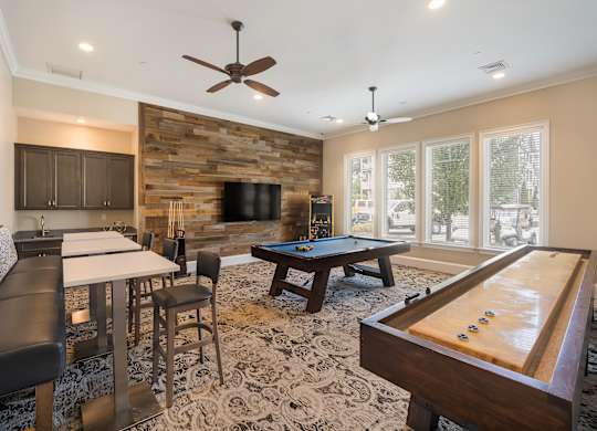 A room with a pool table and a fireplace.