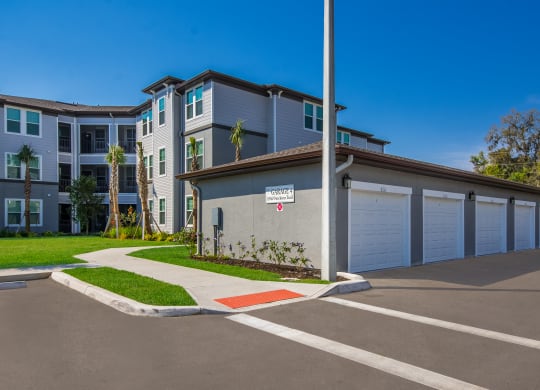 a building with a garage and a street sign in front of it  at The Oasis at Manatee River, Bradenton, FL, 34211