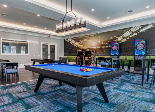 a game room with a pool table and arcade games at the sanctuary at kiawah at The Oasis at Manatee River, Bradenton, FL, 34211