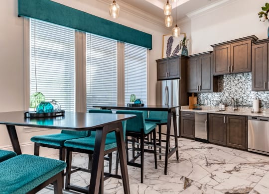 a kitchen with dark wood cabinetry and marble flooring at The Oasis at Manatee River, Florida