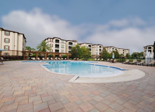 a large swimming pool in front of an apartment complex at The Oasis at Moss Park, Orlando, 32832