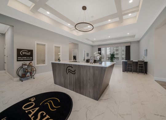 a large reception area with a large desk and a black rug  at The Oasis at Plymouth, Plymouth, MA