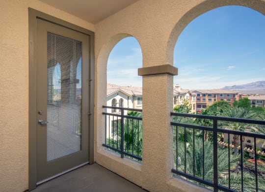 a balcony with a door and a view of the city at Loreto & Palacio Apartments, Las Vegas, Nevada