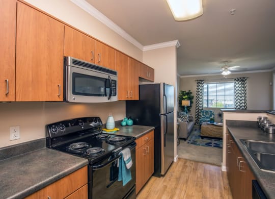 full kitchen with stainless steel appliances and granite counter tops and at Loreto & Palacio Apartments, Las Vegas, NV