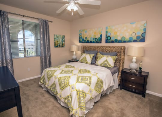 a bedroom with a large bed and a ceiling fan at Loreto & Palacio Apartments, Las Vegas, NV