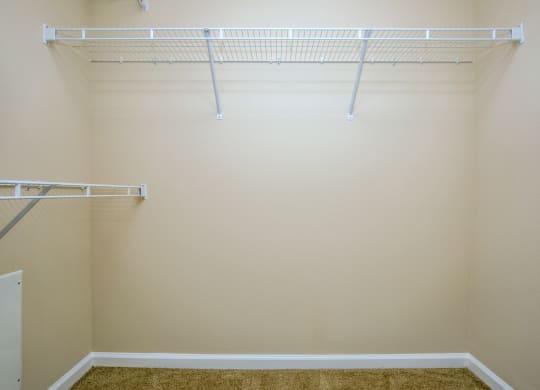 a walk in closet in an empty room with white shelves at Loreto & Palacio Apartments, Las Vegas, 89149