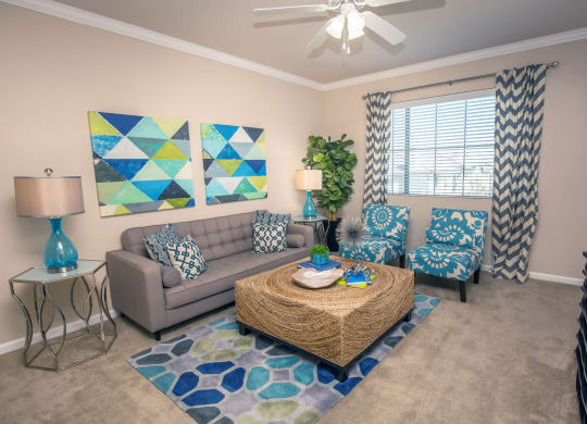 a living room with couches and a coffee table at Loreto & Palacio Apartments, Las Vegas, NV 89149