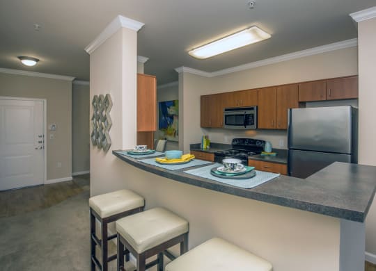 a kitchen with high counter top and a sink and a refrigerator at Loreto & Palacio Apartments, Las Vegas, 89149