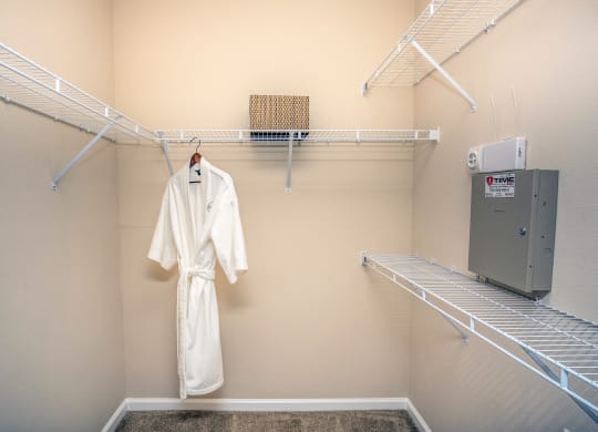 a spacious closet with a robe and a clothes rack at Loreto & Palacio Apartments, Nevada
