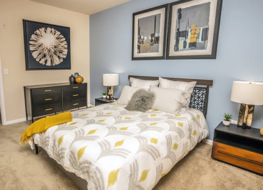 a bedroom with a bed and pictures on the wall at Loreto & Palacio Apartments, Las Vegas, 89149