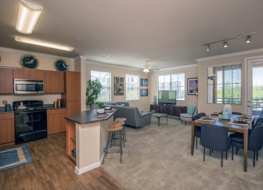 an open living room and kitchen with a dining room table and chairs at Loreto & Palacio Apartments, Las Vegas