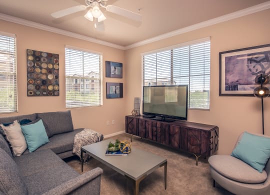 a living room with a couch and a television at Loreto & Palacio Apartments, Las Vegas, Nevada